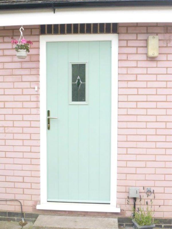 blue composite door in pink brick house