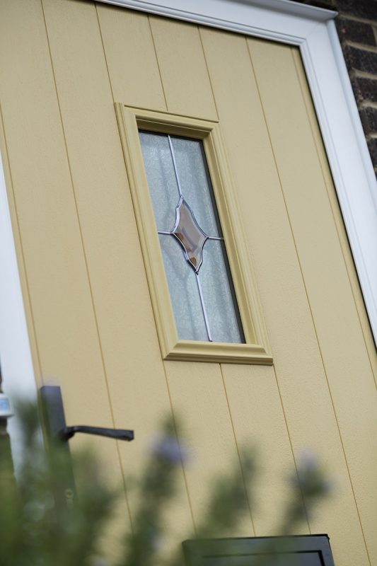 yellow composite door with patterned glass