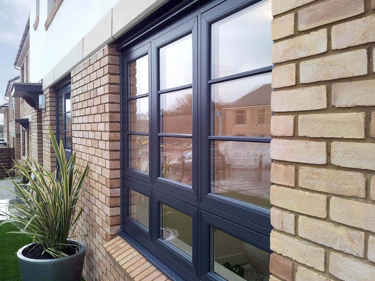 Brick home with large replacement window and plant