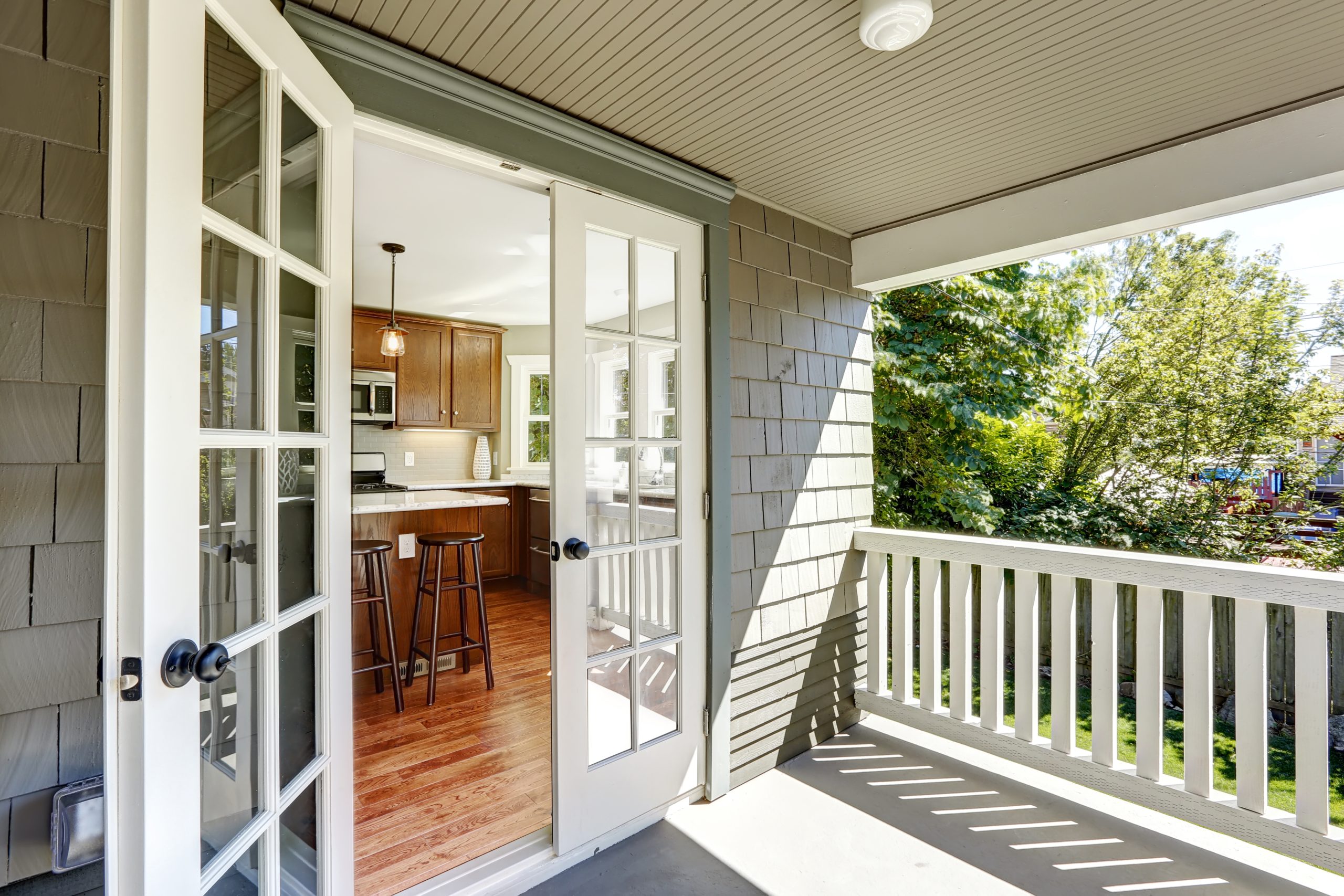 French doors with grey decking leading into kitchen