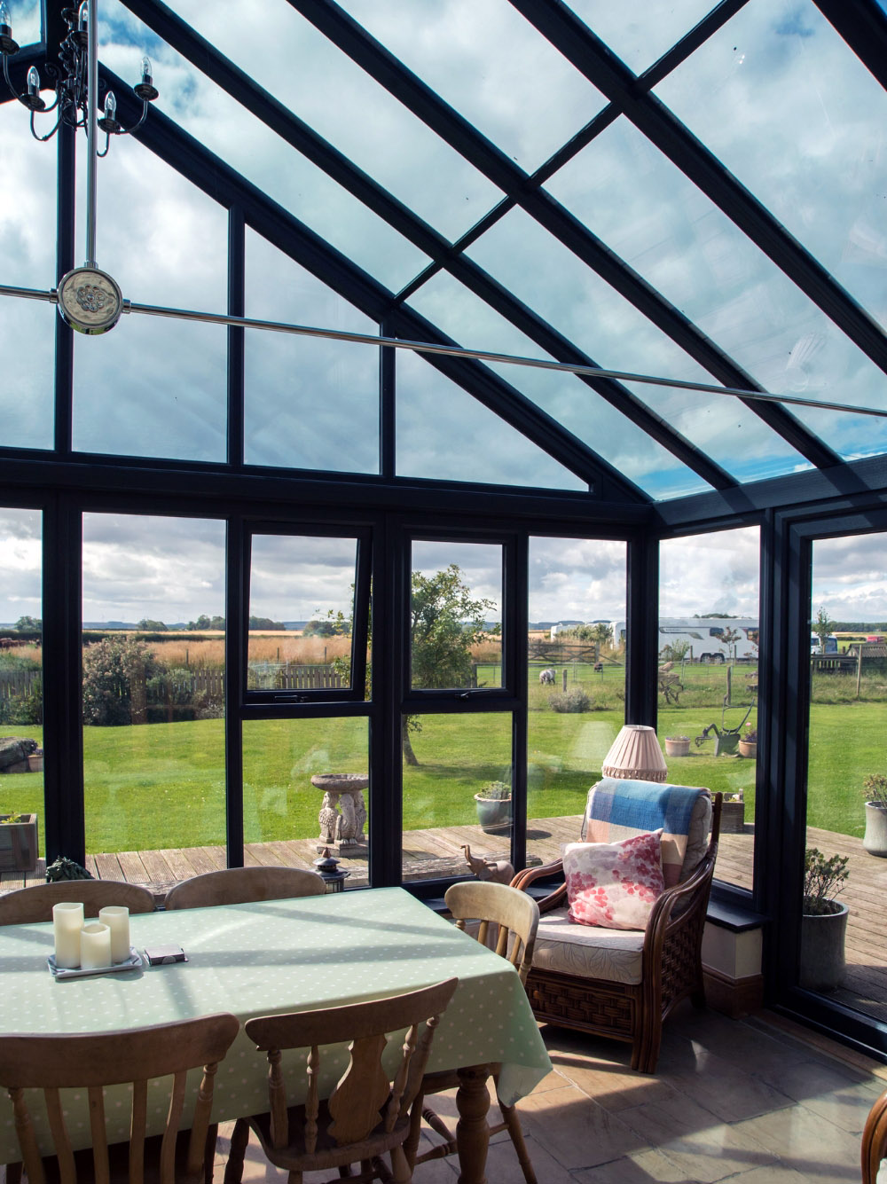 gable conservatories Kidderminster with dining table and chairs and countryside view