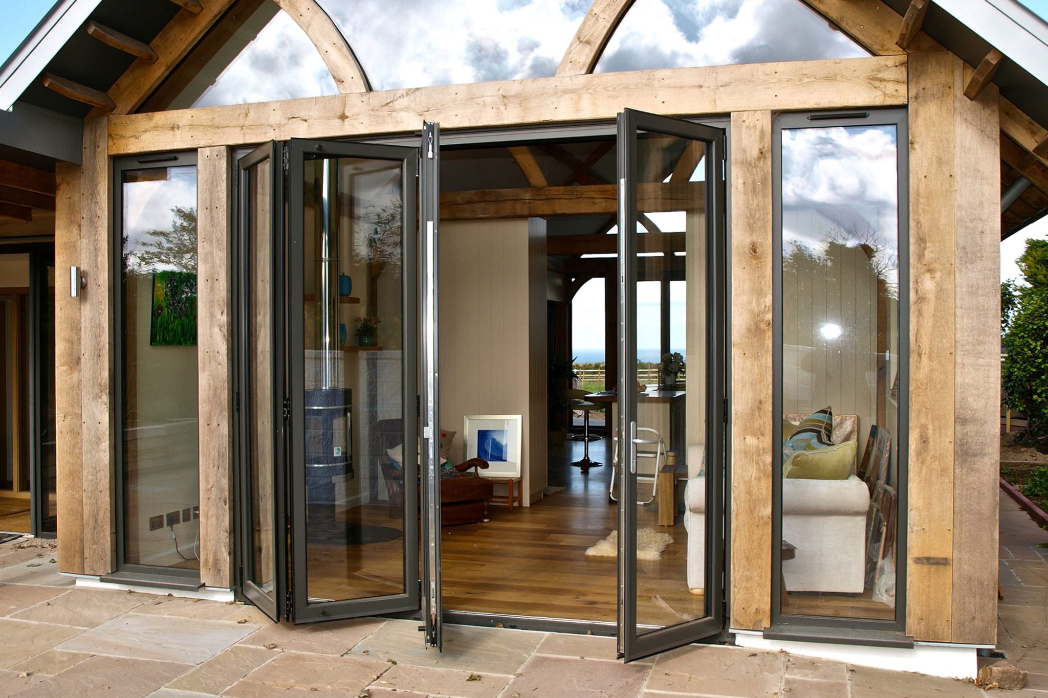 bifold patio doors Redditch in glazed extension with wooden beams